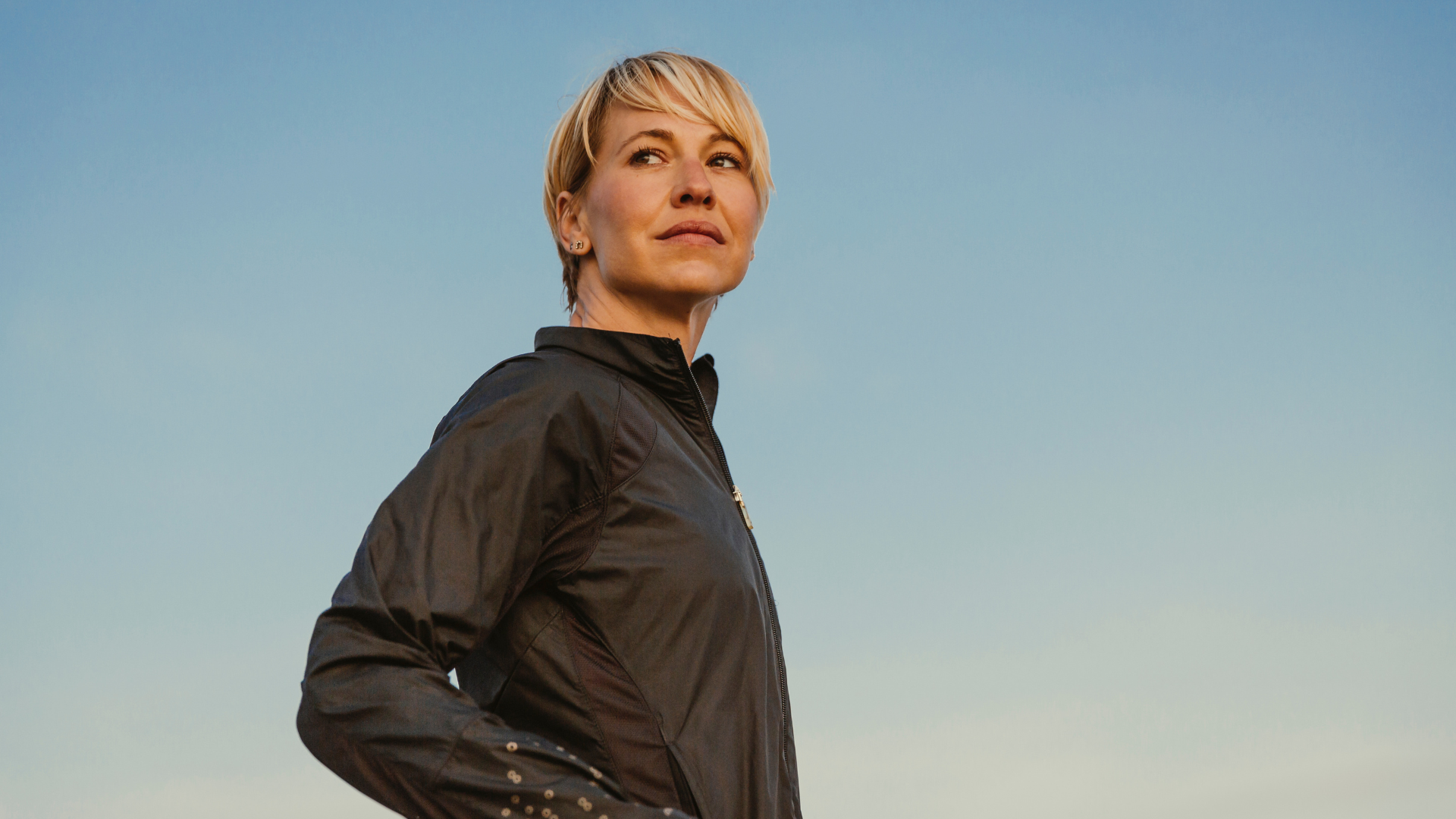 Confident woman looks in distance as if reflecting on her experience